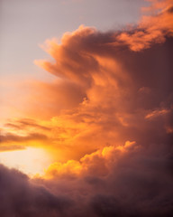 Beautiful Colorful Orange, Yellow and Pink Sunset Burning through the clouds in the sky