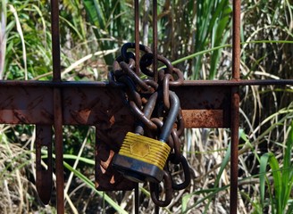 Padlock locking a private property, an empty lot in Dourados, Mato Grosso do Sul, Brazil.