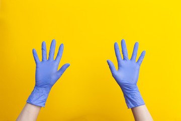 Doctor hands in medical lilac rubber gloves showing open palms,