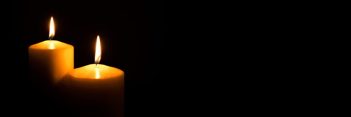 Flame candles isolated on black background. Close up. Copy space.