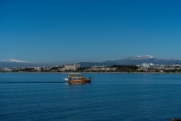 boat in the blue sea near the city