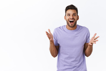 Surprised, excited and fascinated handsome bearded man express astonishment as heard about interest...