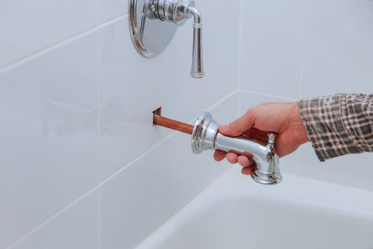 Plumber Installing Water Faucet With Bathroom