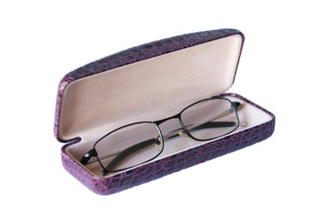old black glasses in a leather case on a white background