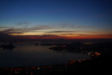 Sunset at Niteroi and Rio de Janeiro cities, Brazil. View of tourist spots in the cities, such as Guanabara Bay, Sugarloaf Cable Car, Christ the Redeemer statue