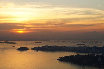 Sunset at Niteroi and Rio de Janeiro cities, Brazil. View of tourist spots in the cities, such as Guanabara Bay, Sugarloaf Cable Car, Christ the Redeemer statue