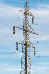 high voltage tower on cloudy sky background 