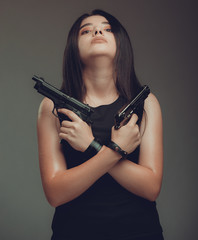 Shot of a sexy military woman posing with guns