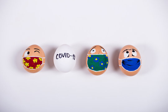 Diverse chicken eggs with doodle faces wearing medical masks. Conceptual image of Easter during Corona virus epidemic lockdown. Quarantine at home...