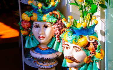 Colorful traditional ceramics vases in Positano store reflex