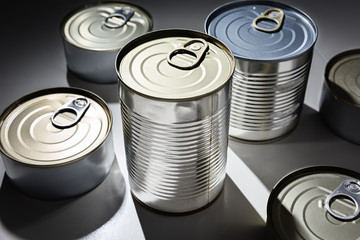 Various canned goods on top of white surface.