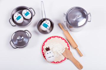 Easter in quarantine of Corona virus epidemic lockdown. Baking or cooking background frame. Ingredients, kitchen items for baking cakes. Kitchen ustensils, flour, eggs, Text space, top view.