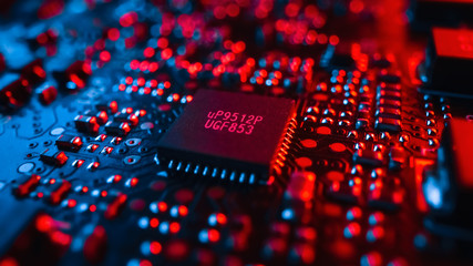 Close-up Macro Shot of Microchip, CPU Processor, Printed Circuit Board or Computer Motherboard with Components: Inside of Electronic Device. Neon Colors. Cyber Security Safety Concept.