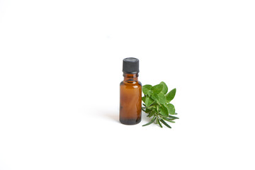 Bottle with herb essential oil on white background. Herbs bouquet.