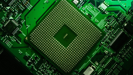 Macro Close-up Shot of CPU Processor Socket on Green Printed Circuit Board or Computer Motherboard with Components Inside of Electronic Device, Parts of Supercomputer. Lit by Green Light.