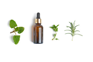 Bottle with herb essential oil on white background. Flat lay concept.