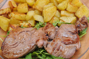 beef grilled fillet meat  on rocket salad and potatos  