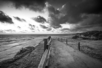 black and white path leading to ocean