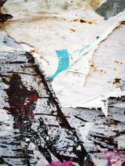 Layers of old colorful posters on wall damaged by time for your grunge style design