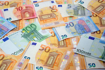 Obraz na płótnie Canvas tangent policy, money - euro banknotes (100 €, 50,20,10,5 ) - inflation and increase in the cost of living - devaluation euros, spread and economic crisis - stock exchange and finance