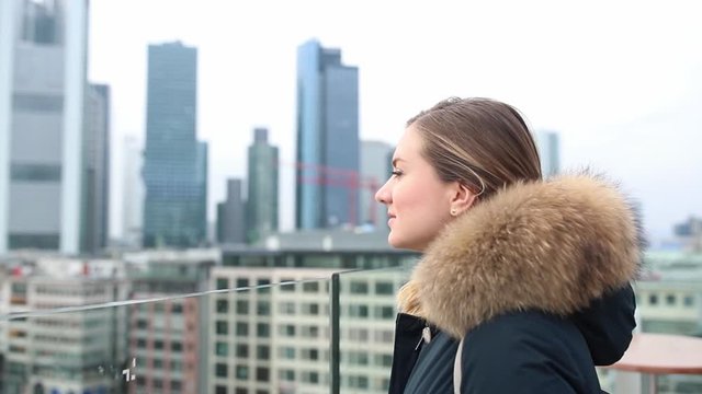 Beautiful girl against the backdrop of skyscrapers