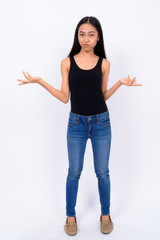 Full body shot of young Asian woman shrugging