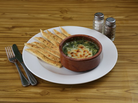 Baked spinach with cheese crust in casserole