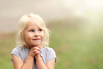 Beautiful Little 4 Year Old Girl Child Smiling Sweetly as She Prays