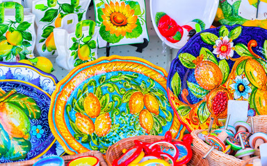 Traditional colorful ceramics plates on display in Ravello reflex