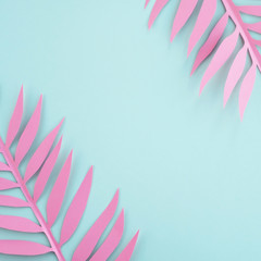Fototapeta na wymiar Summer background. Pink paper palm leaves, minimal composition in pastel colors. Top view, flat lay, copy space