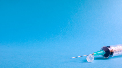 syringe on blue background