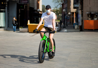 young man riding a bicycle during quarantine