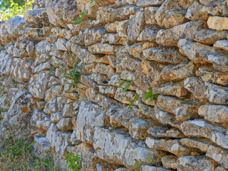 Detail of traditional drywall as a fence of dirt road in Promina county in Croatia. Croatian drywall construction is a protected intangible cultural heritage of humanity by UNESCO.