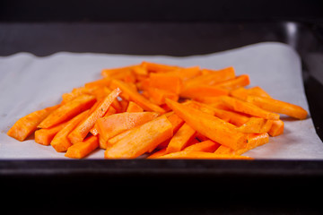 Raw sweet potato on the metal tray.