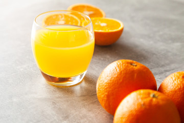 Fototapeta na wymiar Fresh orange juice on the table and citrus fruits
