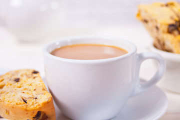 Italian biscotti and cup of coffee with milk. Close up.