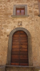 Fototapeta na wymiar Bagno Regio, Italy, Old building and saint