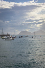 Motor boats in the harbor. Sea coast. Sea off the coast of Spain. Yachts in the water area. Landscape with boats and yachts. Water transport. Calm off the coast of the Spanish city. Boats on the water