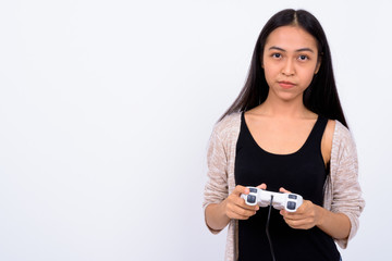 Portrait of young beautiful Asian woman playing games