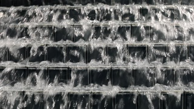 Close Up Row of Square Tiles Lined up on Stairs With water Sliding