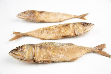 Three salted fish on a white background