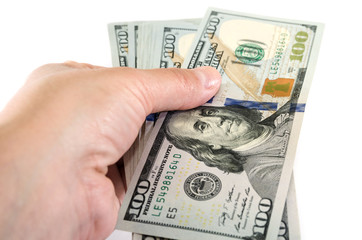dollars in hand on a white background, close-up. Give or take dollars.