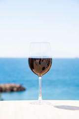 
Glass of red wine on a terrace near the Mediterranean sea, Aguilas, Murcia, Spain