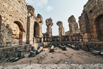 Fototapeta premium Ancient city of Perge near Antalya Turkey. Ancient Ruins of Rock and Stone in the evening sun.