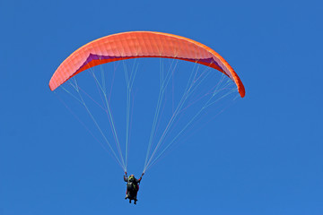 Paraglider flying wing in a blue sky	