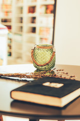 
jar for candles notepad and lavender on a table in a cafe