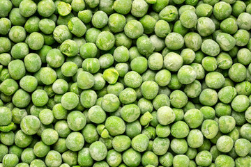 closeup background and texture of frozen green peas
