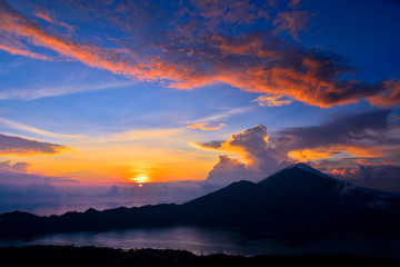 Sun is rising behind the volcano Mount Batur, Bali, Indonesia 