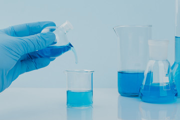 scientific laboratory equipment. hands of a scientific researcher in blue gloves