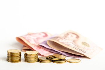 Pile of coins and blurred banknote.Thai Money on white background. save money concept. 